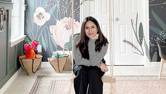 DIY influencer Fariha Nasir sitting on a swing smiling